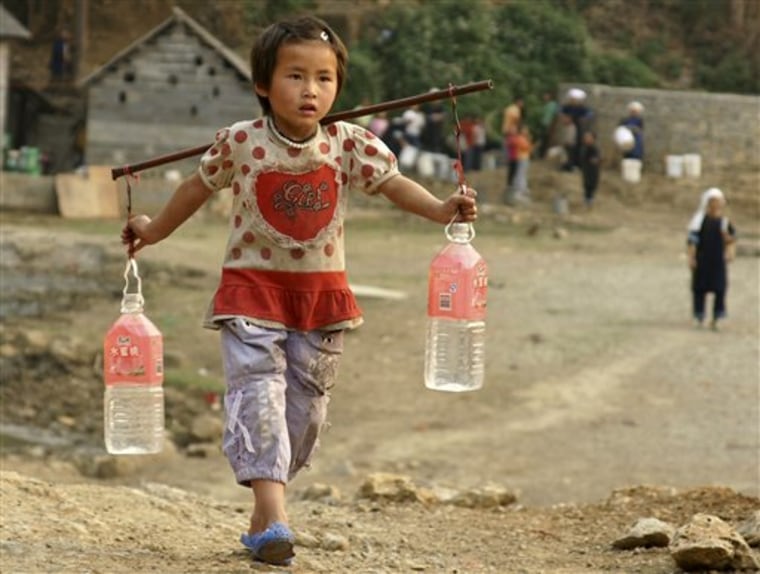A girl fetches water from a mountain spring at a village in China's Guizhou province on Monday.